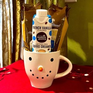 Snowman ceramic mug filled with two packages of Harry & David coffee and creamer